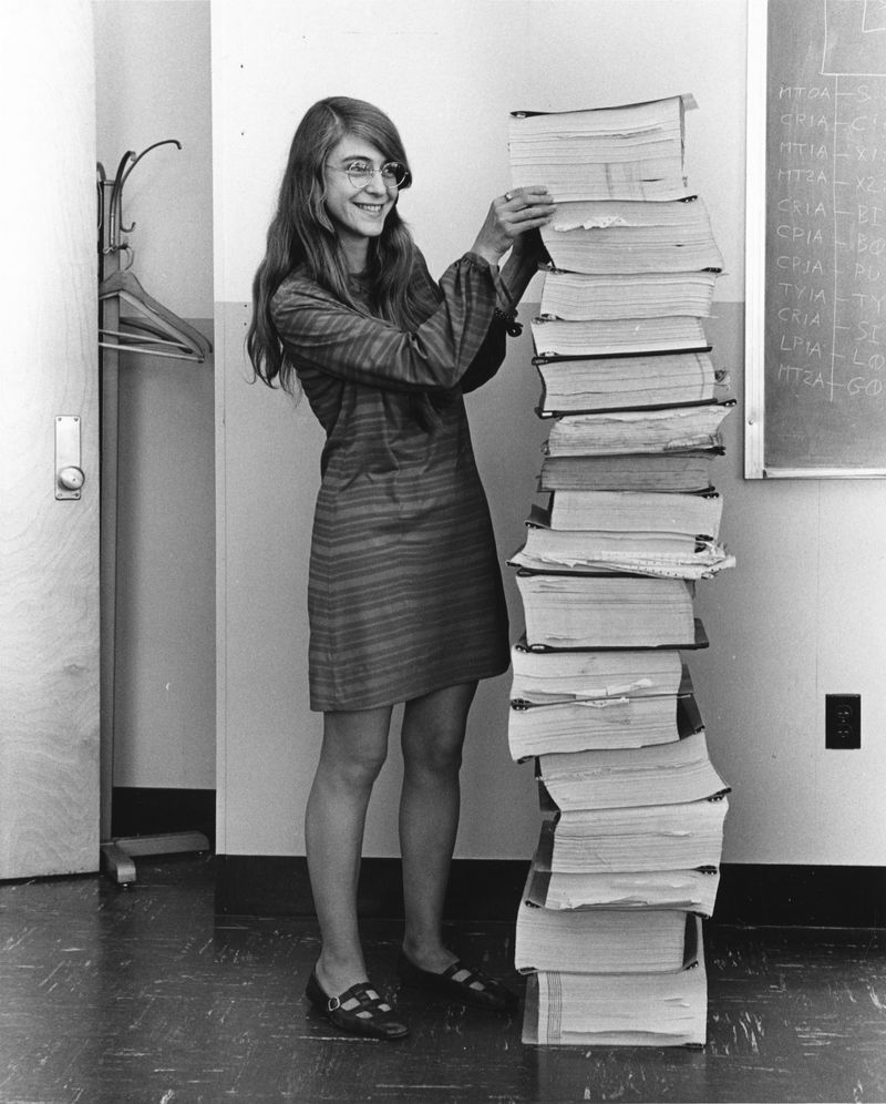  Margaret Hamilton standing next to the navigation software that she and her MIT team produced for the Apollo Project.